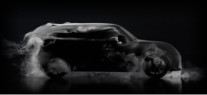Side-view of the silhouette of a MINI covered in a dark lacquer.